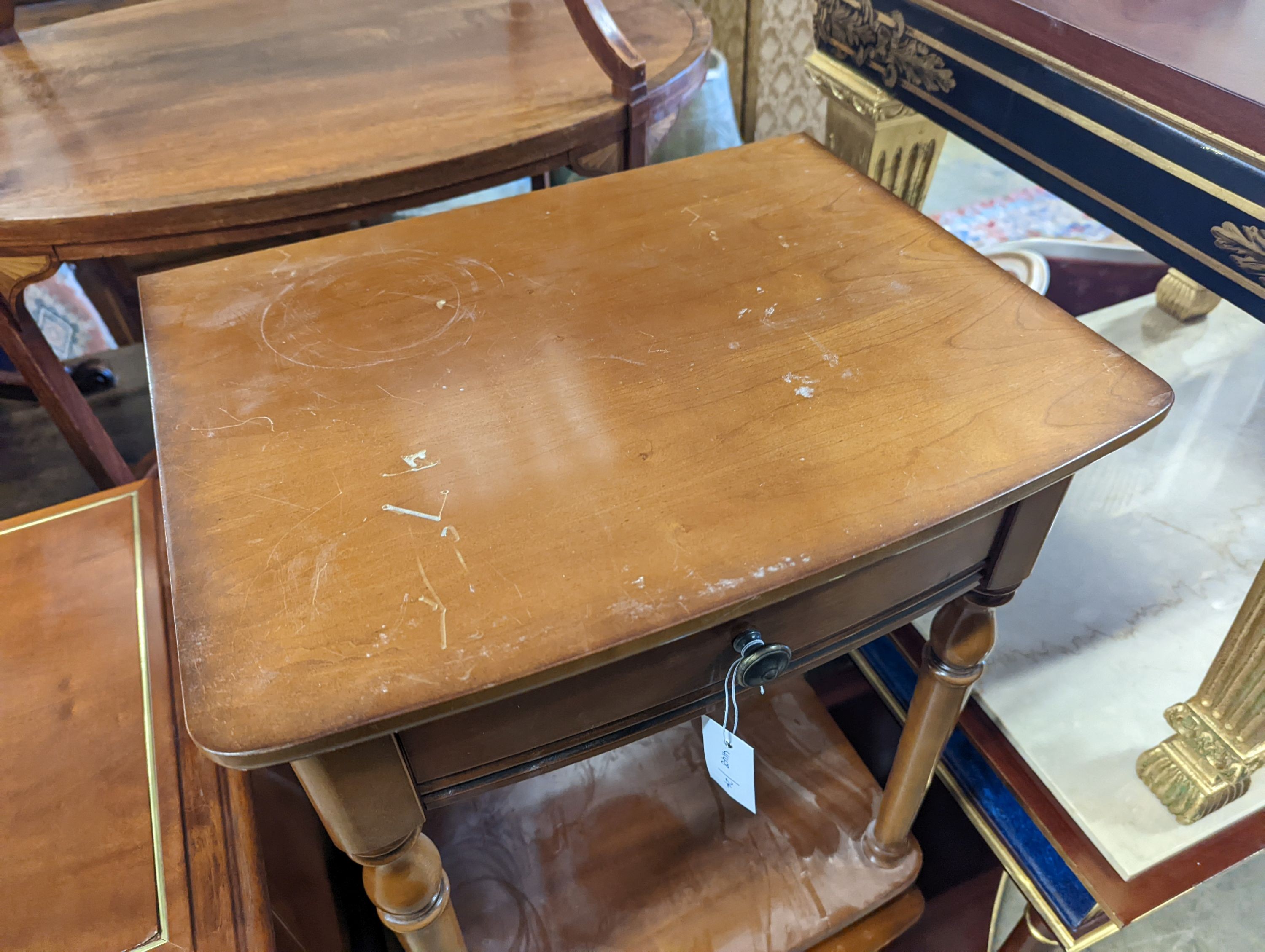 A pair of walnut bow front two tier bedside tables, width 47cm, depth 38cm, height 72cm